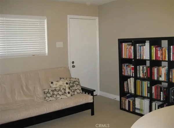 a view of a livingroom with a book shelf