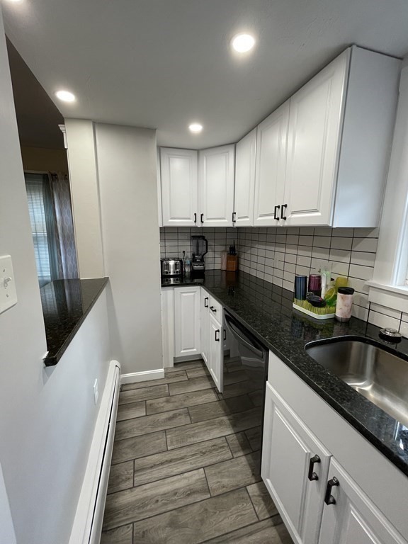 9 Thayer Street Worcester, MA 01603 - Photo 2 of 18 a kitchen with stainless steel appliances granite countertop a sink a stove and a refrigerator