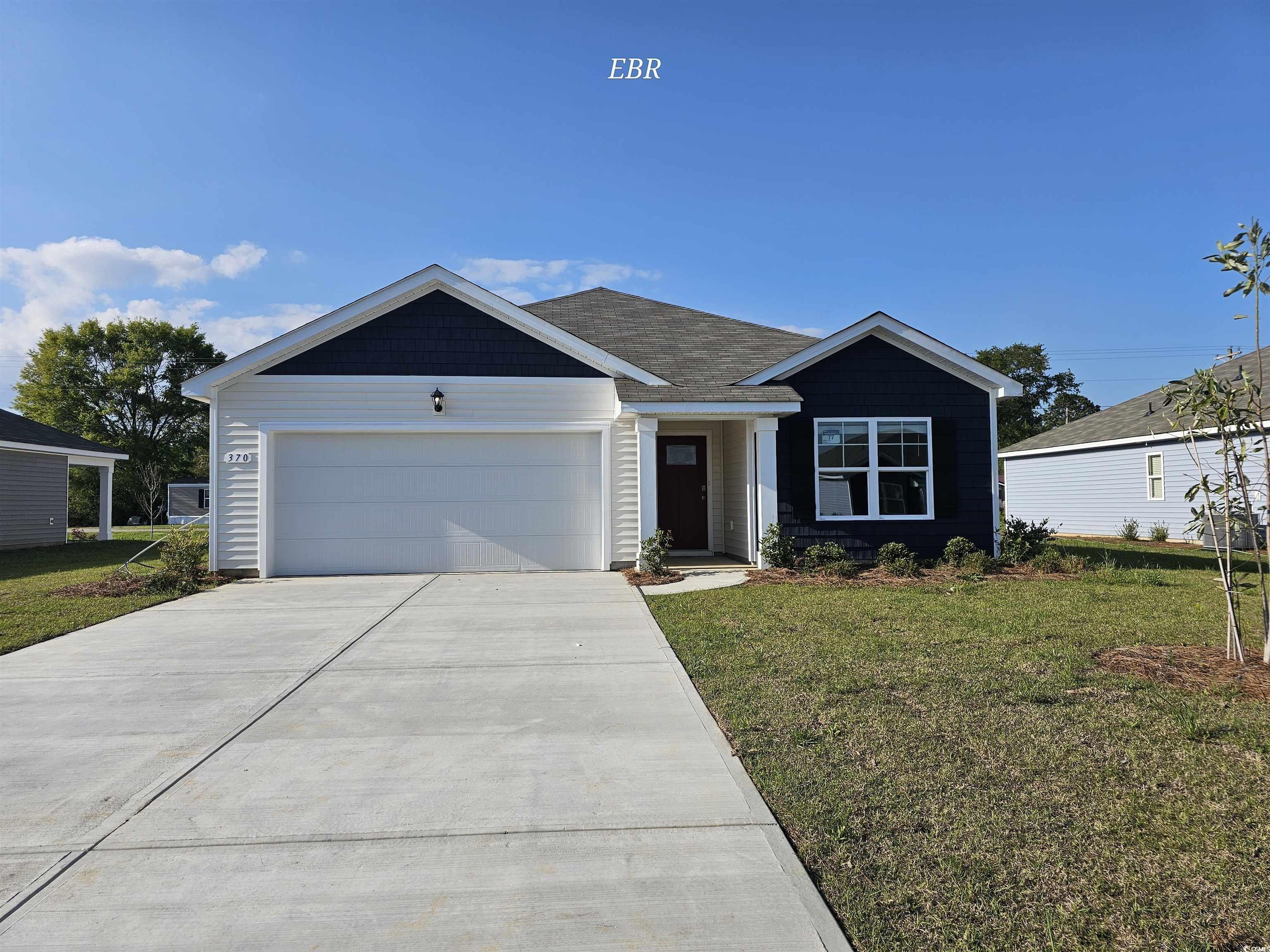 Ranch-style home featuring an attached garage, con