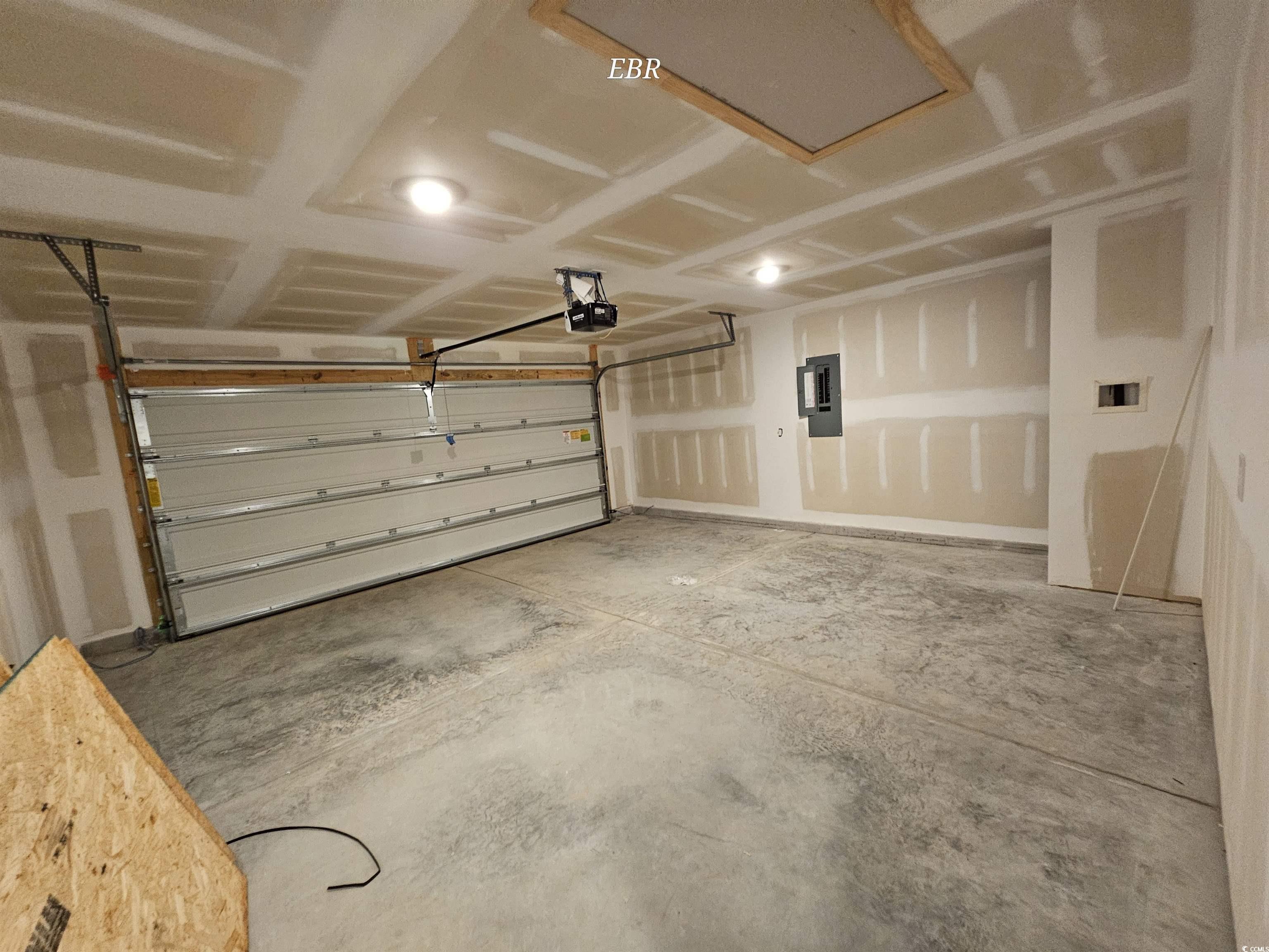 370 Jeff Waters Circle Longs, SC 29568 - Photo 14 of 14 Garage with electric panel and a garage door opene