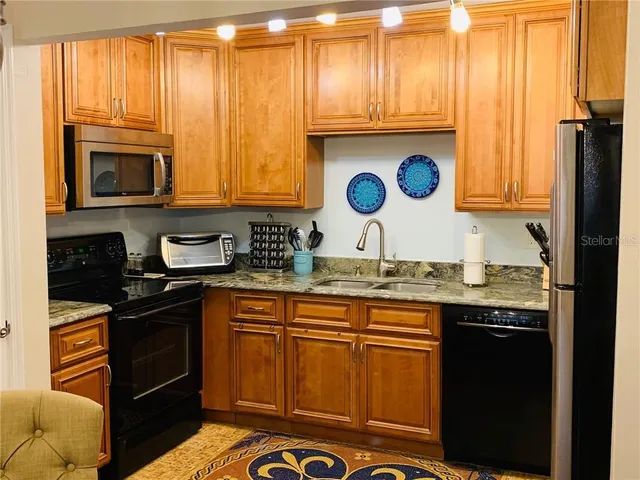 a kitchen with stainless steel appliances granite countertop a stove and a microwave