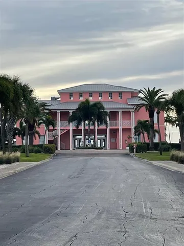 a living room with furniture a large window and kitchen view