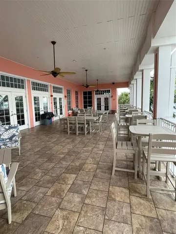 a room with pool table and windows