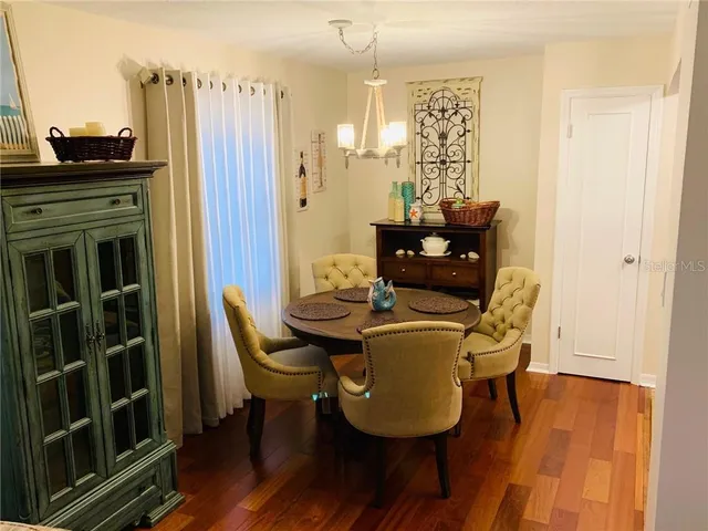 a dining room with furniture and wooden floor