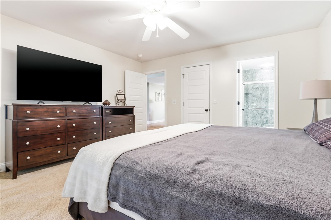 1110 Sunset Lane Anderson, SC 29626 - Photo 12 of 38 Comfortable carpeted bedroom featuring a ceiling fan and convenient access to a modern bathroom.