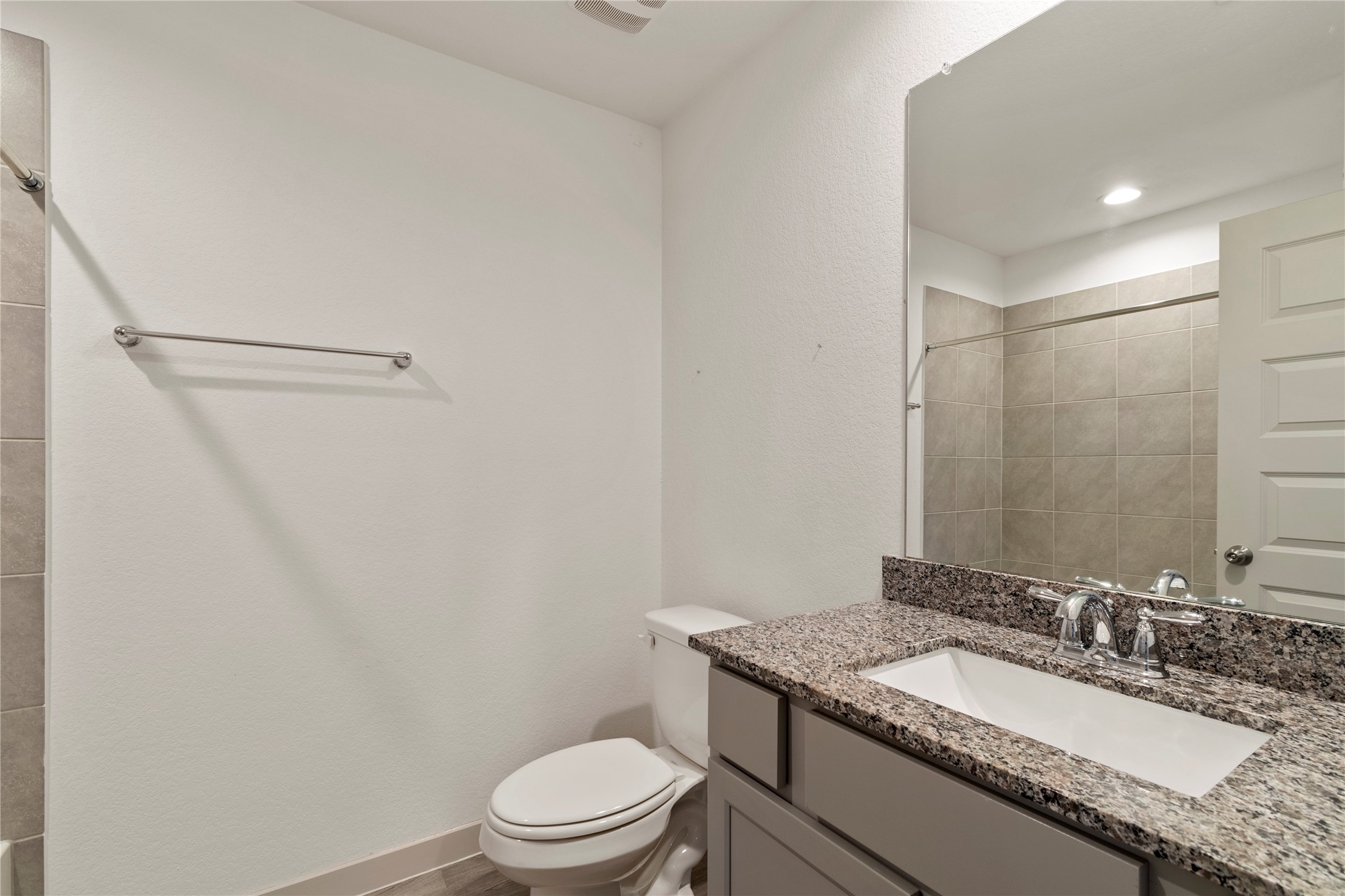 1203 Truckee River Drive Rosharon, TX 77583 - Photo 10 of 12 a bathroom with a granite countertop sink a toilet a mirror and shower
