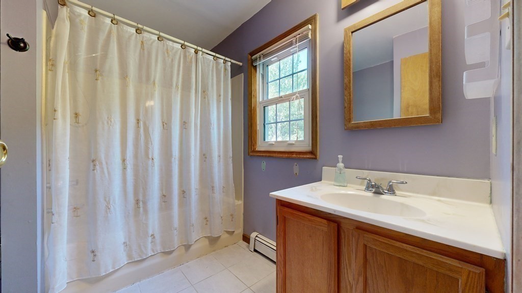 17 Mohave Road Worcester, MA 01606 - Photo 20 of 34 a bathroom with a sink a mirror and a shower curtain