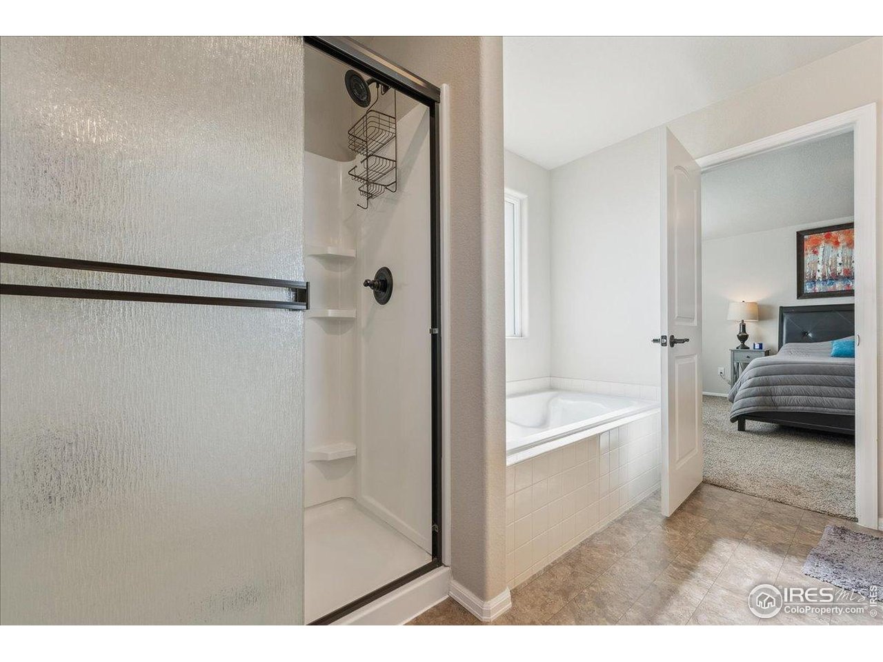 623 Gore Range Drive Severance, CO 80550 - Photo 16 of 36 a bathroom with a tub shower and a sink