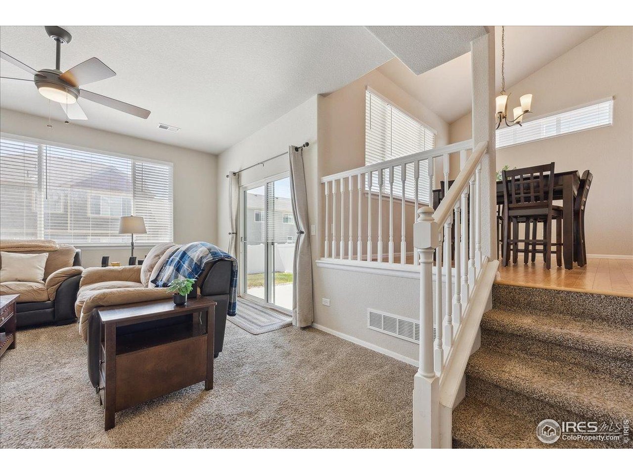 623 Gore Range Drive Severance, CO 80550 - Photo 17 of 36 a living room with furniture and a dining table