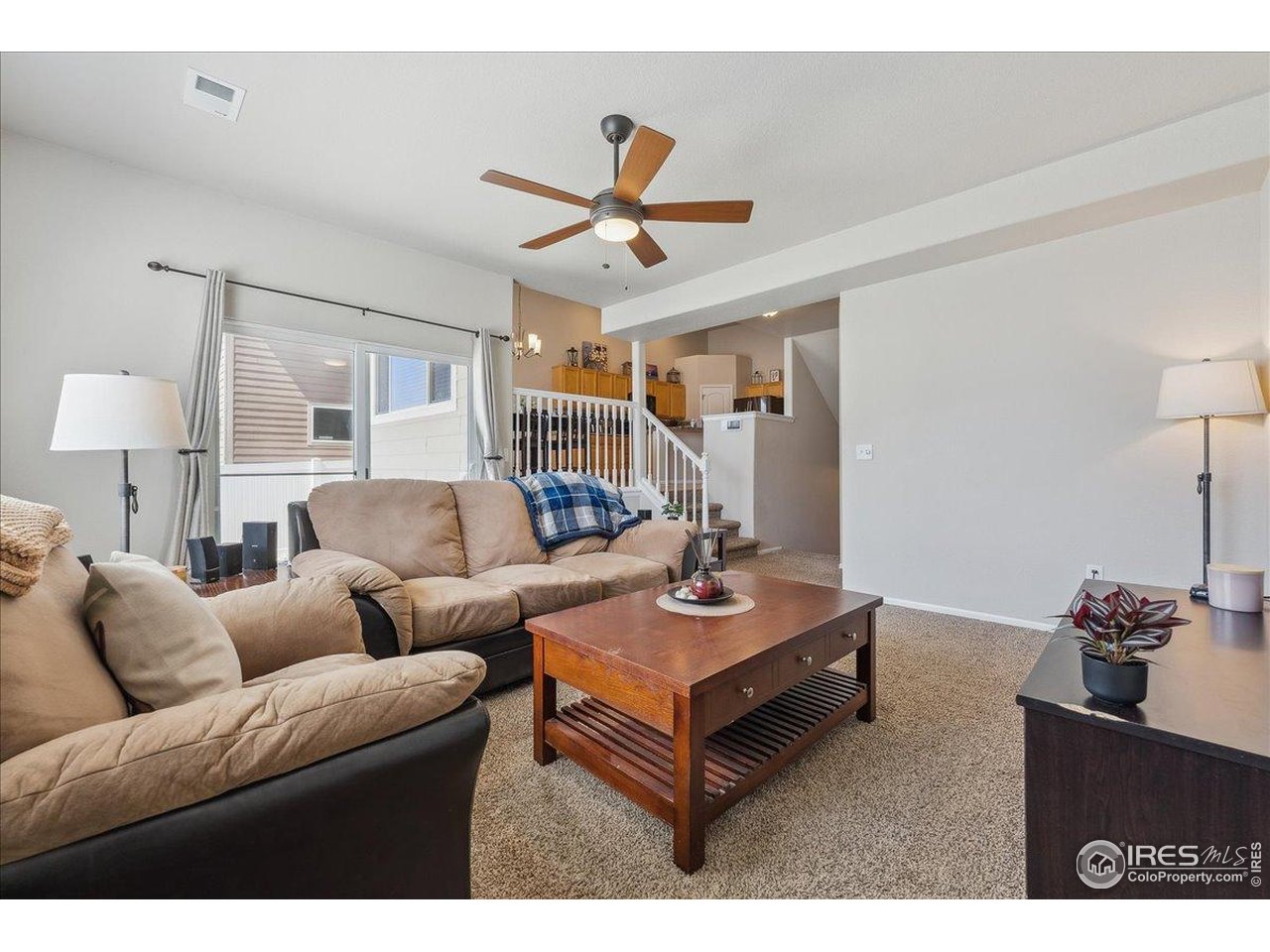 623 Gore Range Drive Severance, CO 80550 - Photo 18 of 36 a living room with furniture a ceiling fan and a rug