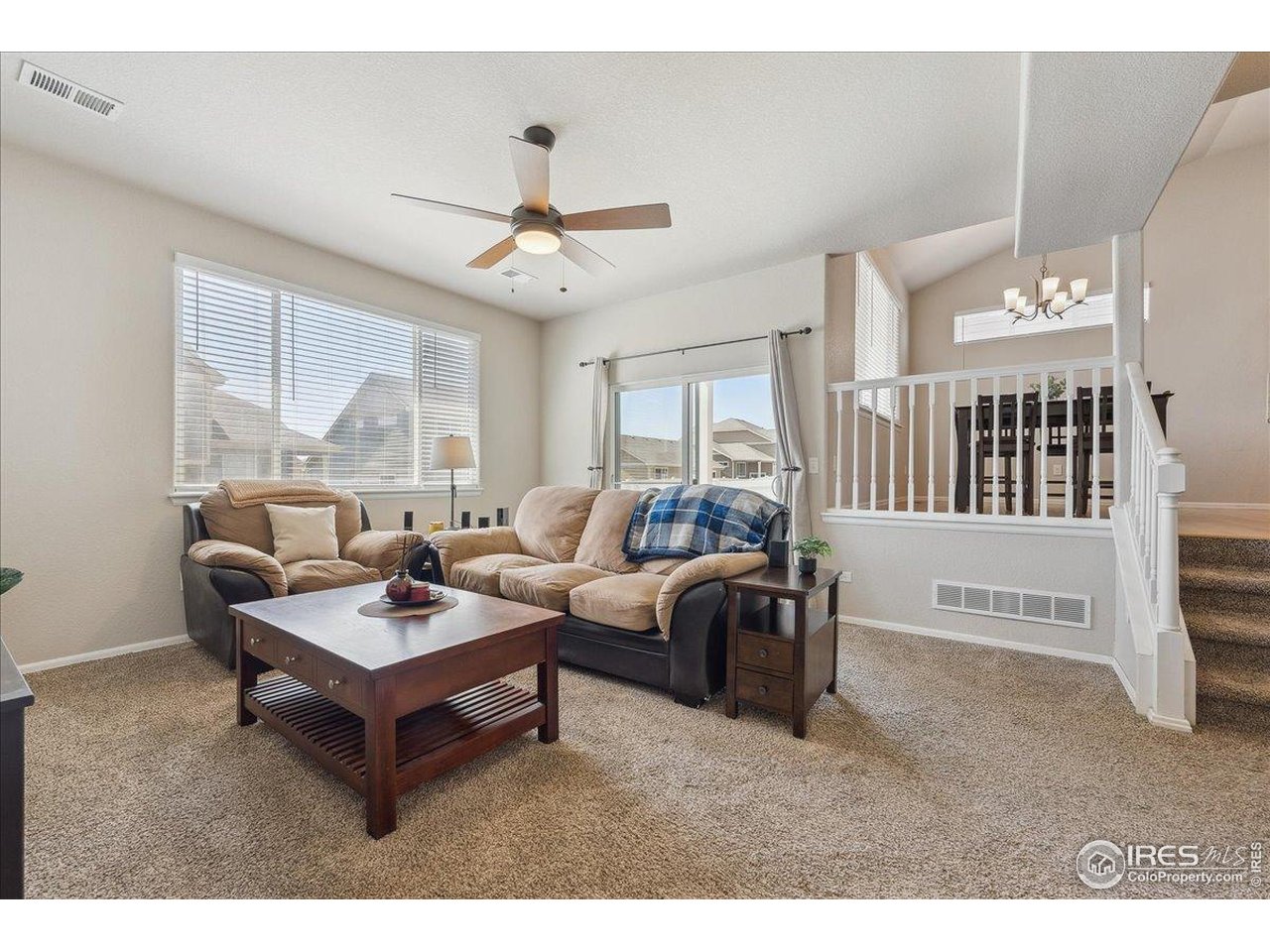 623 Gore Range Drive Severance, CO 80550 - Photo 19 of 36 a living room with furniture and a large window