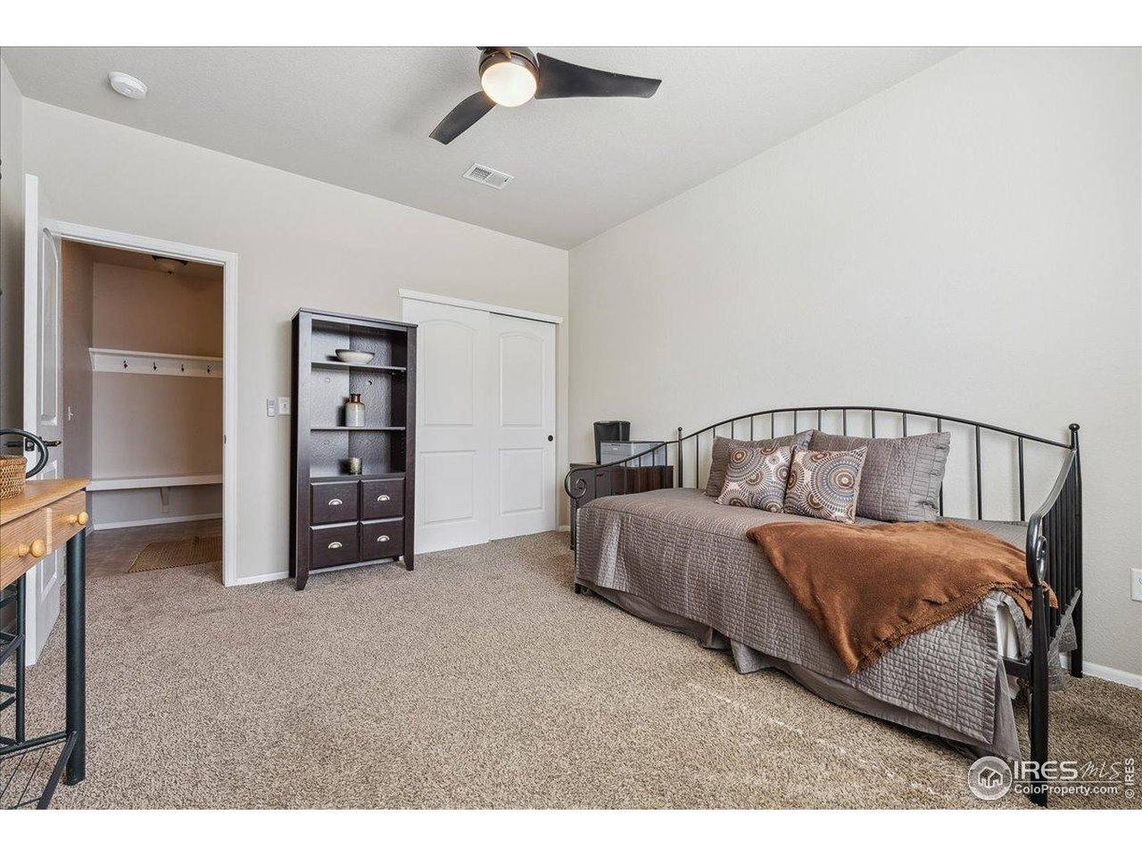 623 Gore Range Drive Severance, CO 80550 - Photo 20 of 36 a spacious bedroom with a bed and a chandelier