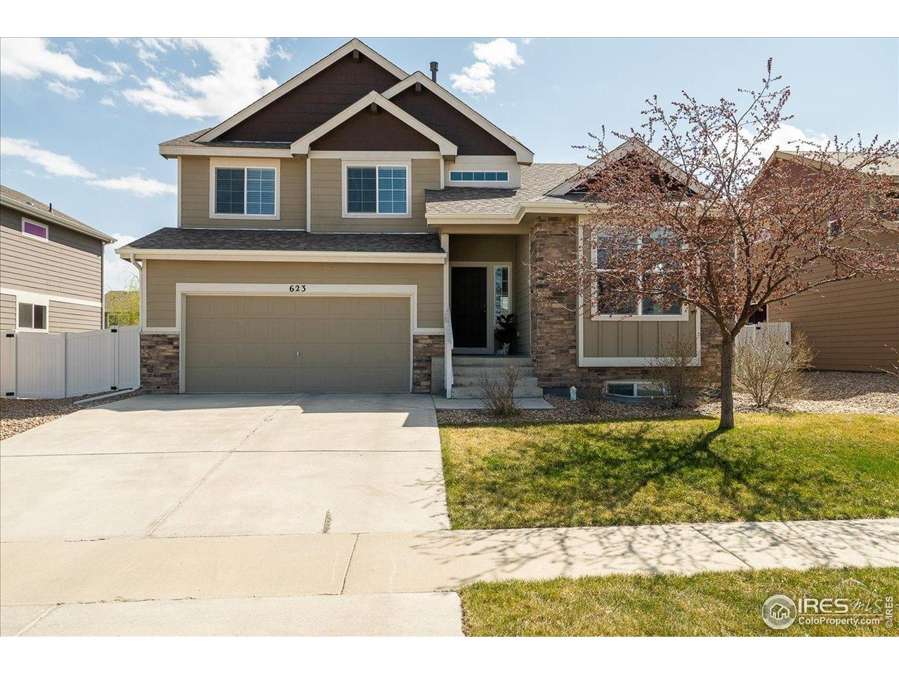 623 Gore Range Drive Severance, CO 80550 - Photo 2 of 36 a front view of a house with garden