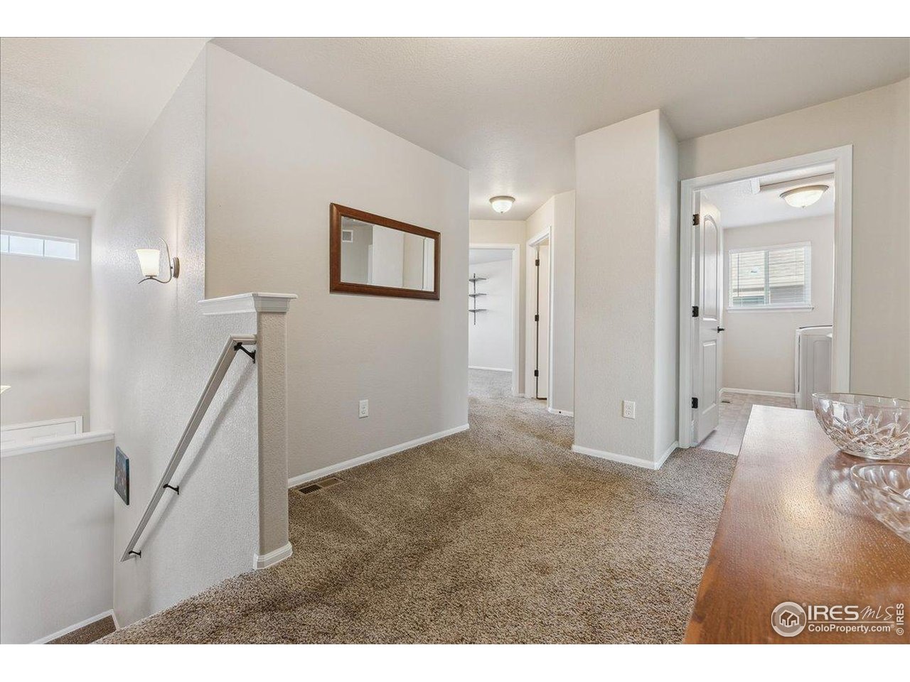 623 Gore Range Drive Severance, CO 80550 - Photo 22 of 36 a view of hallway with furniture and wooden floor