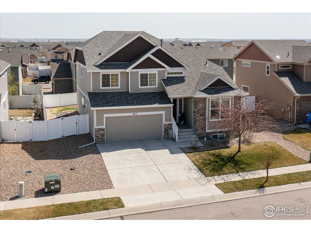 623 Gore Range Drive Severance, CO 80550 - Photo 33 of 36 a view of a white house with a sink and yard