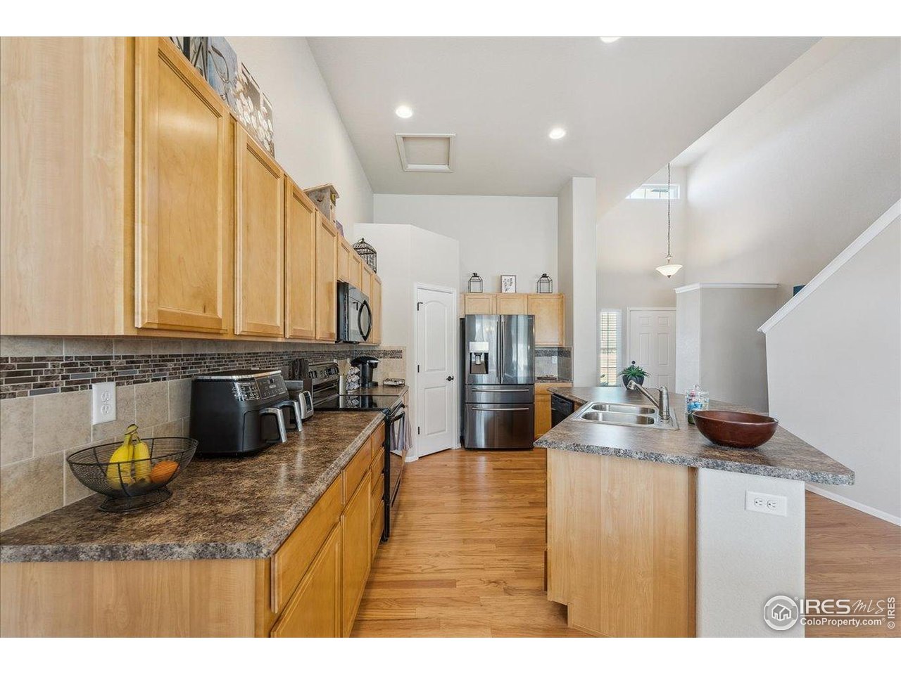 623 Gore Range Drive Severance, CO 80550 - Photo 4 of 36 a kitchen with stainless steel appliances kitchen island granite countertop a sink and cabinets