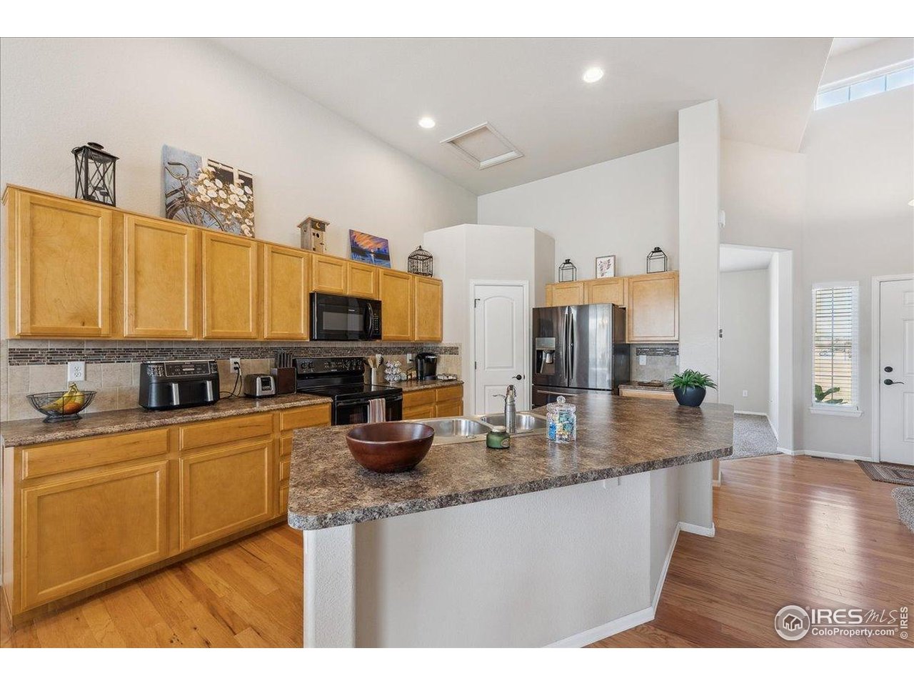 623 Gore Range Drive Severance, CO 80550 - Photo 7 of 36 a kitchen with stainless steel appliances granite countertop a sink stove and refrigerator