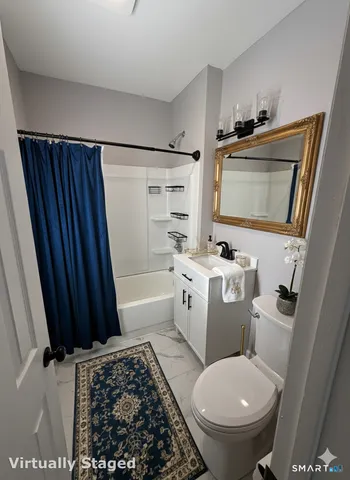 a bathroom with a toilet a sink and a mirror