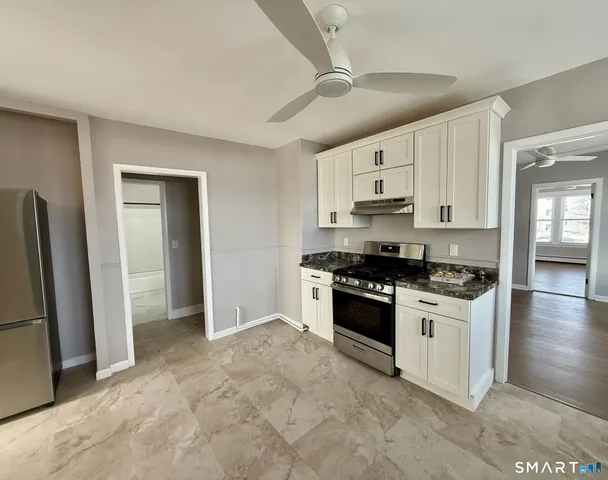 a kitchen with stainless steel appliances granite countertop a stove and a refrigerator