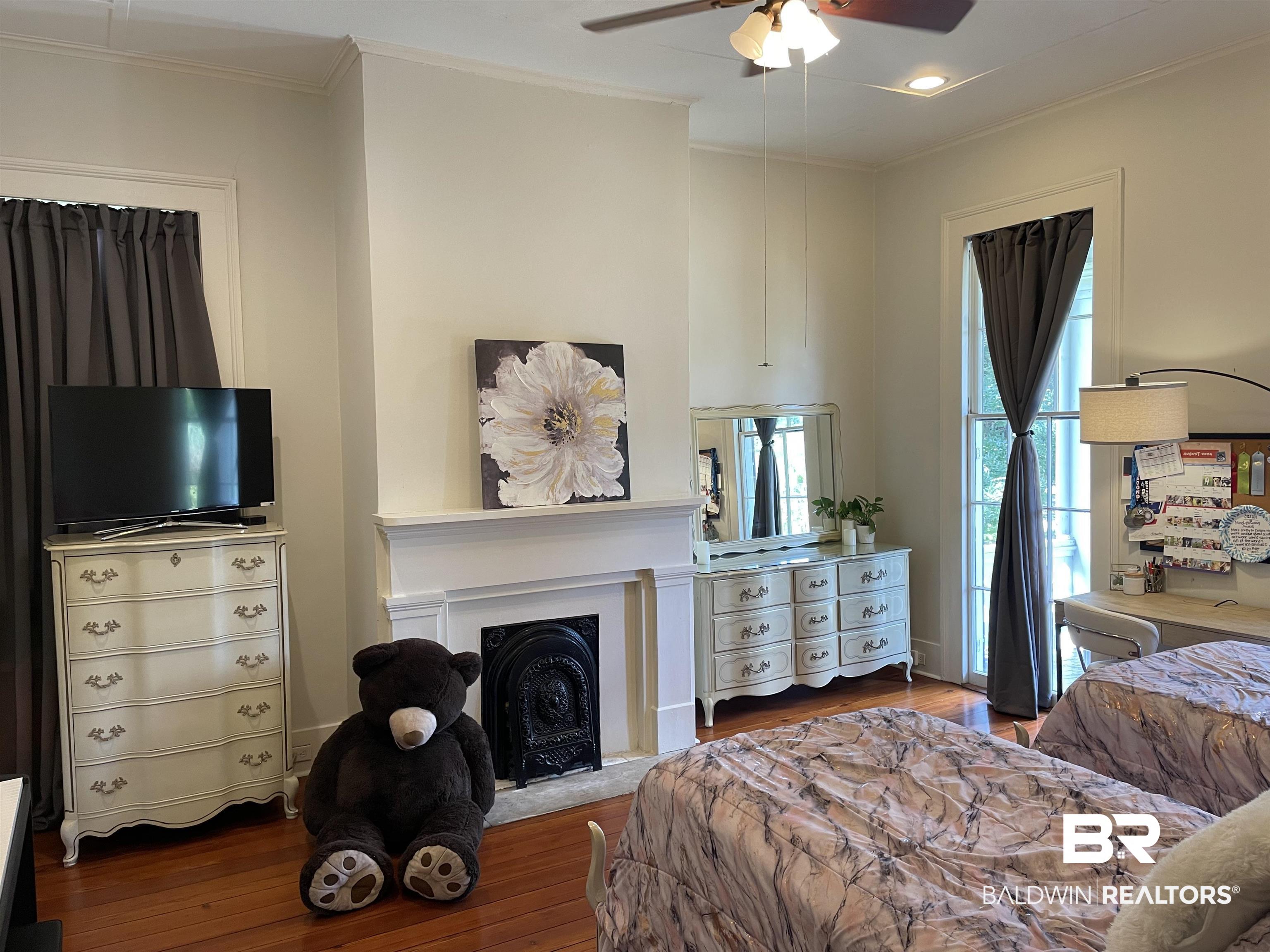 1001 Augusta Street Mobile, AL 36604 - Photo 4 of 26 Bedroom featuring ceiling fan, crown molding, and wood-type flooring