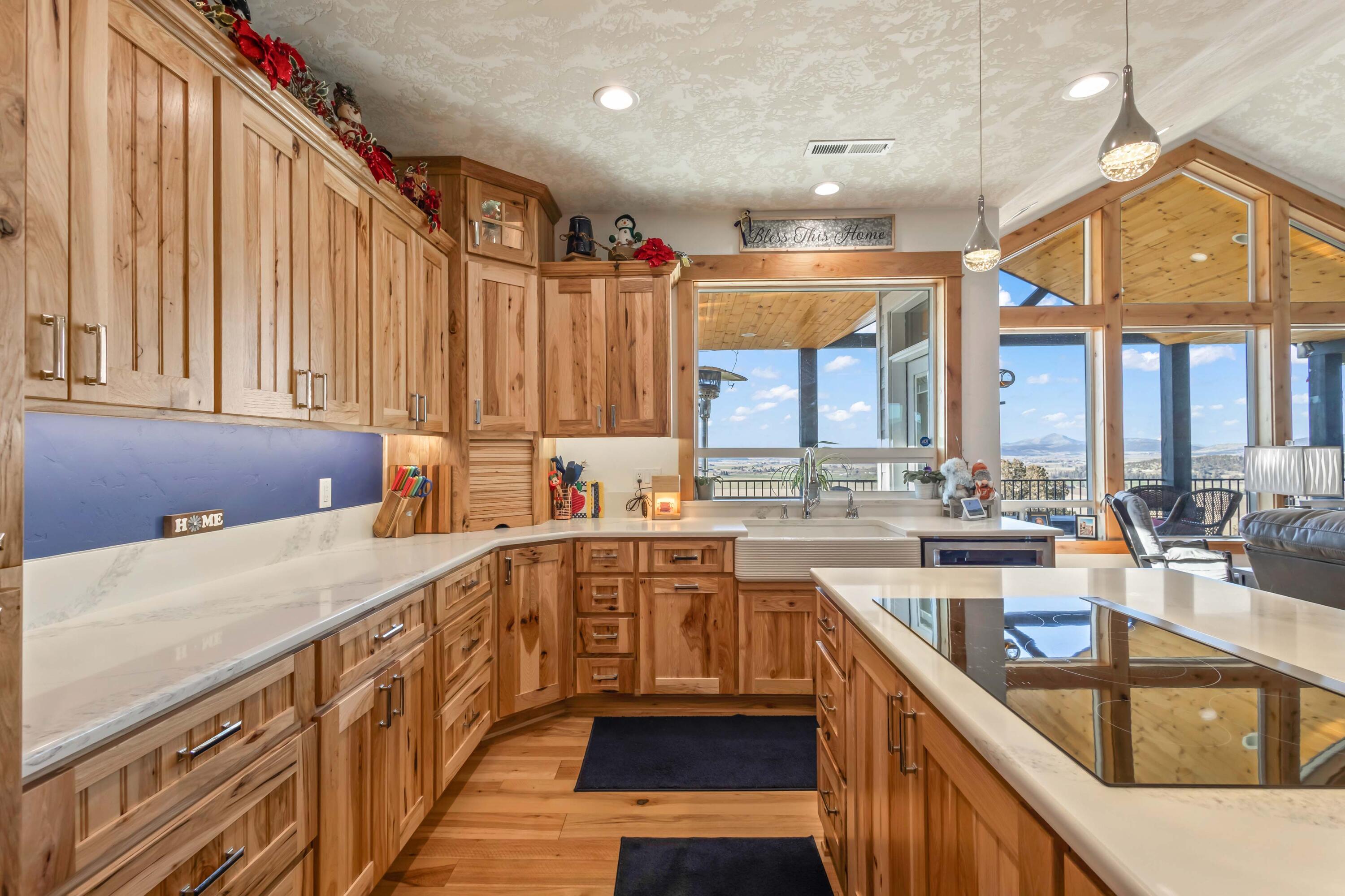 5582 North Mckay Road Prineville, OR 97754 - Photo 13 of 54 a kitchen with stainless steel appliances granite countertop a sink a stove and a refrigerator