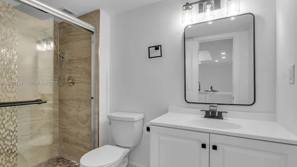 a bathroom with a toilet sink and shower
