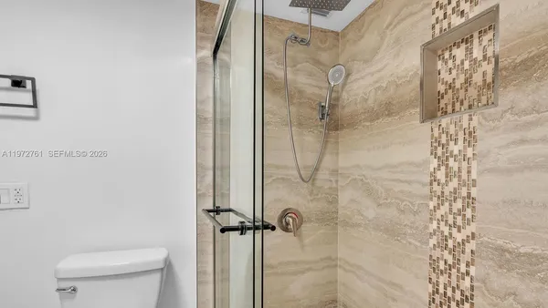 a bathroom with a shower and a toilet