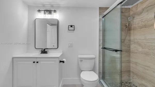 a bathroom with a toilet sink and shower