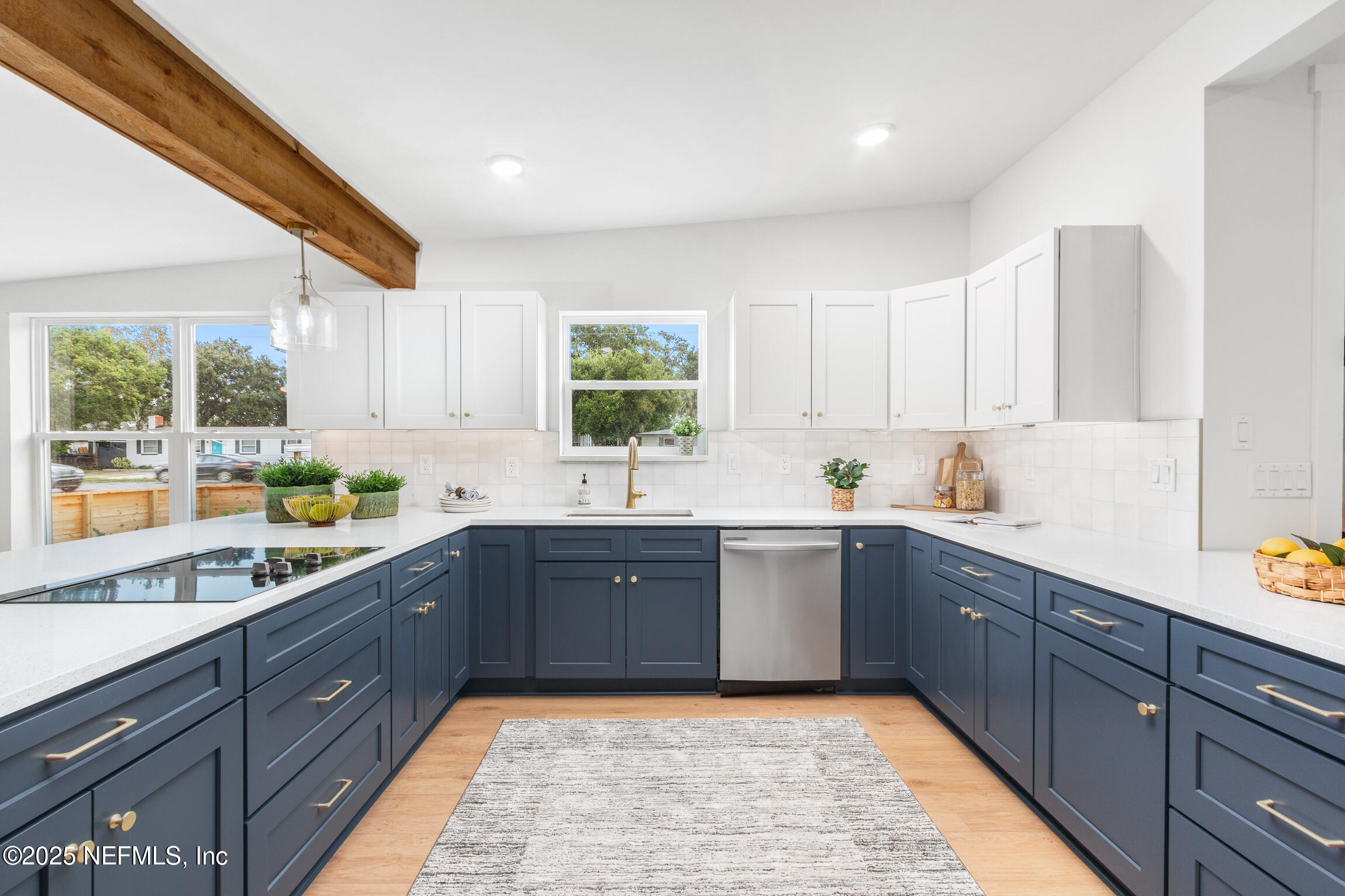 1746 Penman Road Jacksonville Beach, FL 32250 - Photo 11 of 40 a large kitchen with stainless steel appliances granite countertop a sink counter space cabinets and a large window