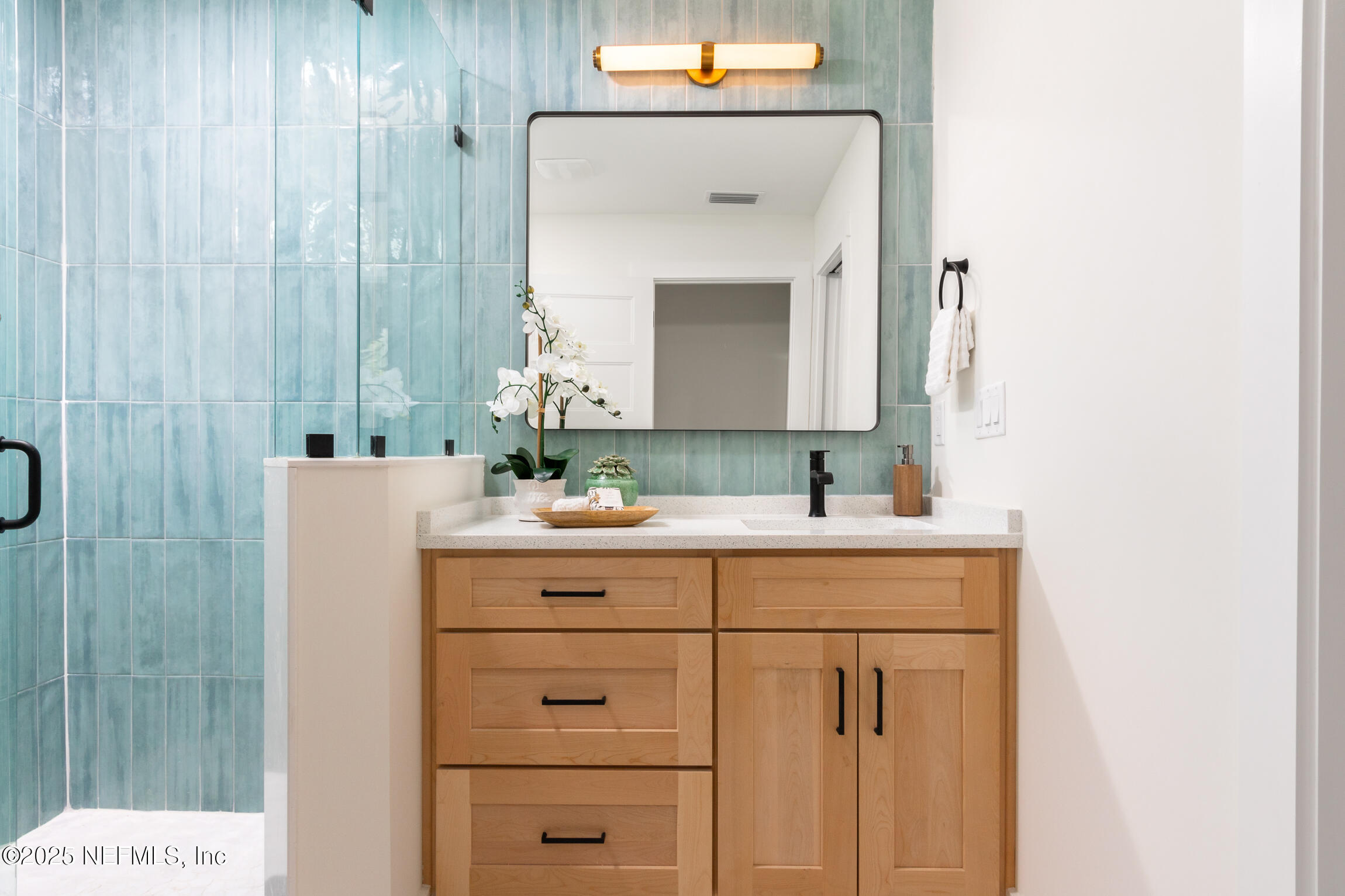 1746 Penman Road Jacksonville Beach, FL 32250 - Photo 24 of 40 a bathroom with a sink vanity and a mirror