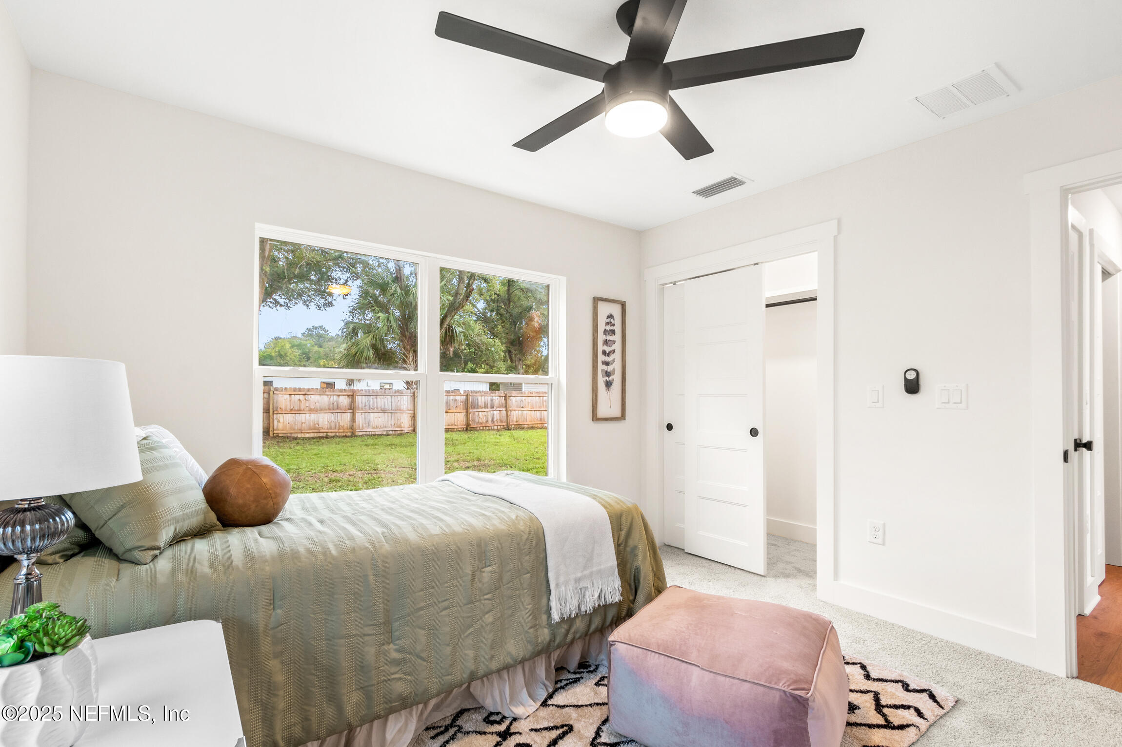 1746 Penman Road Jacksonville Beach, FL 32250 - Photo 32 of 40 a bedroom with a bed and a large window