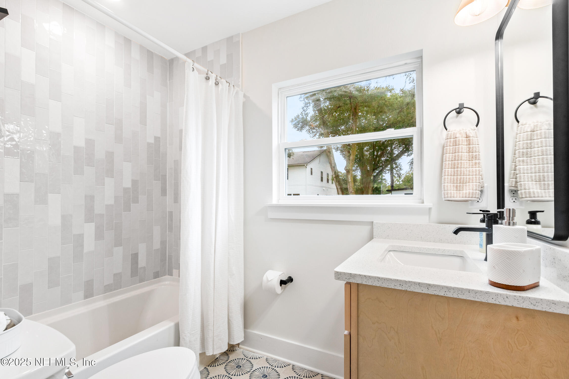 1746 Penman Road Jacksonville Beach, FL 32250 - Photo 33 of 40 a bathroom with a granite countertop sink a large mirror and a shower