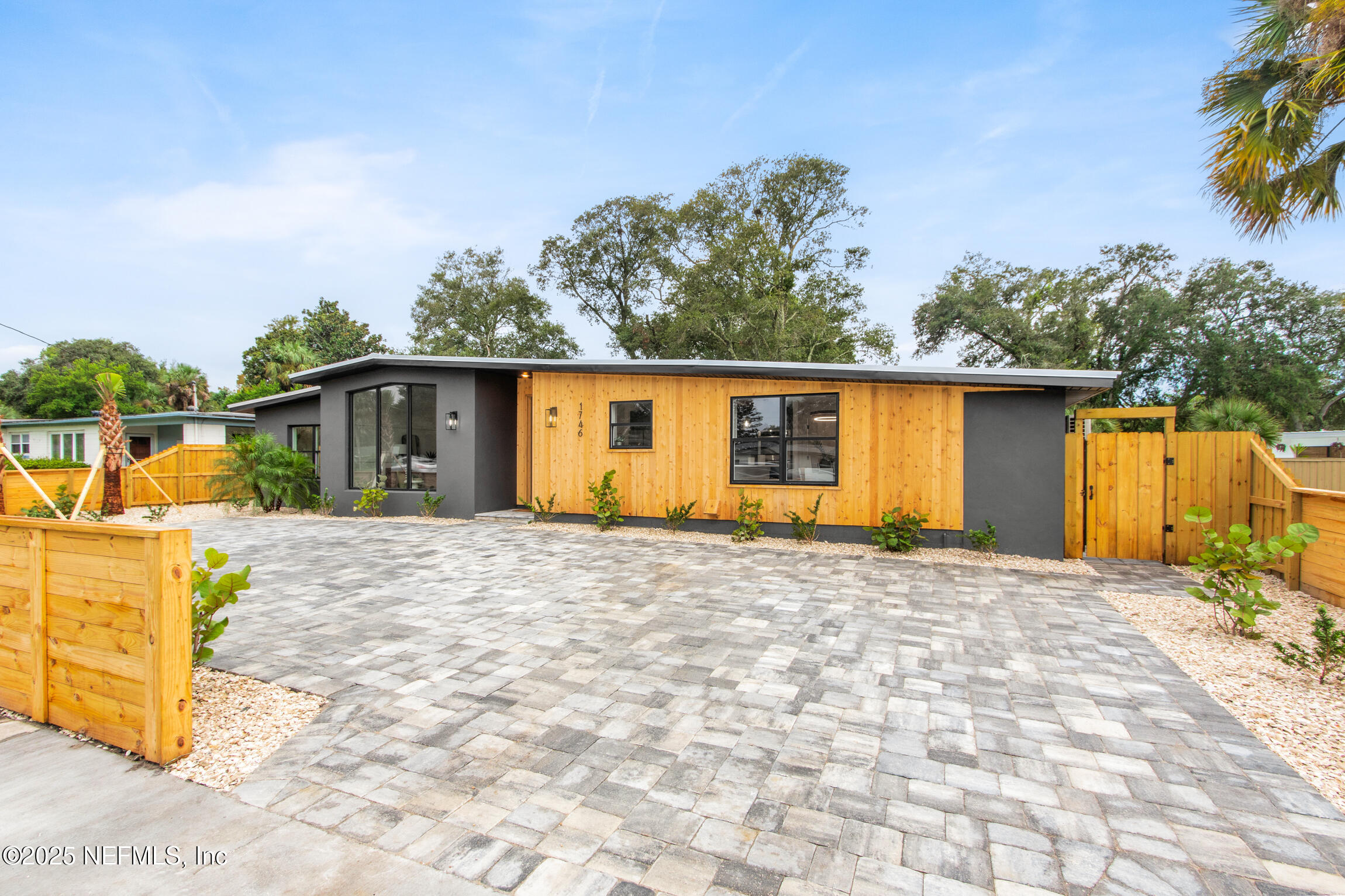 1746 Penman Road Jacksonville Beach, FL 32250 - Photo 4 of 40 a front view of house with yard outdoor seating and barbeque oven
