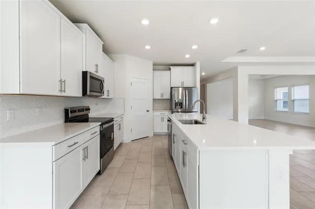 a kitchen with stainless steel appliances sink a microwave and cabinets