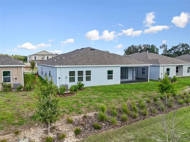a aerial view of a house with a yard and lake view