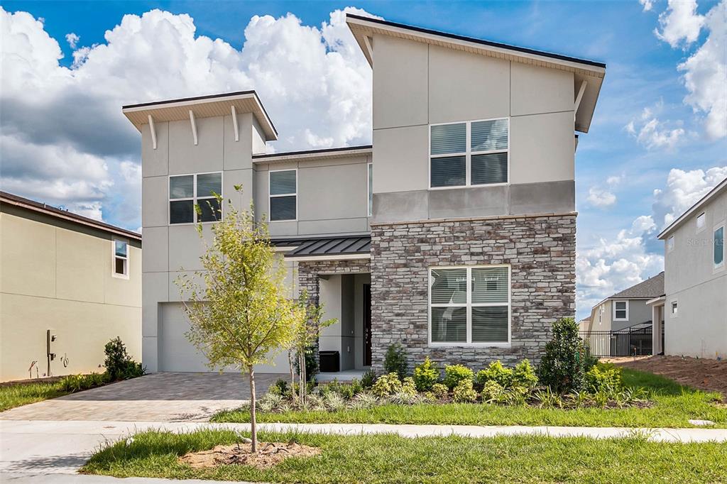 a front view of a house with a yard and garage