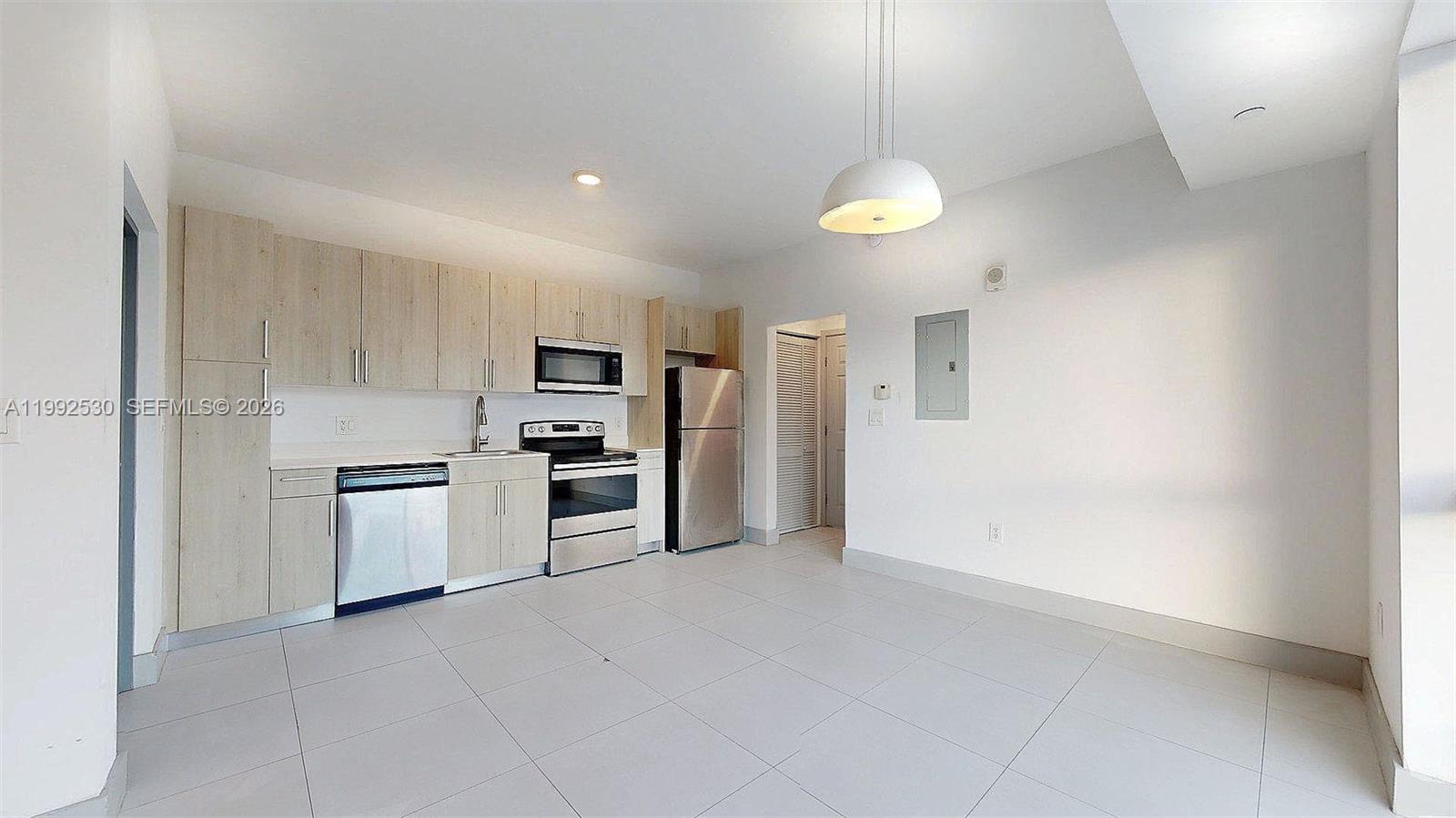 519 Southwest 5th Avenue, Unit 203 Miami, FL 33130 - Photo 11 of 26 a kitchen with stainless steel appliances a refrigerator sink and stove