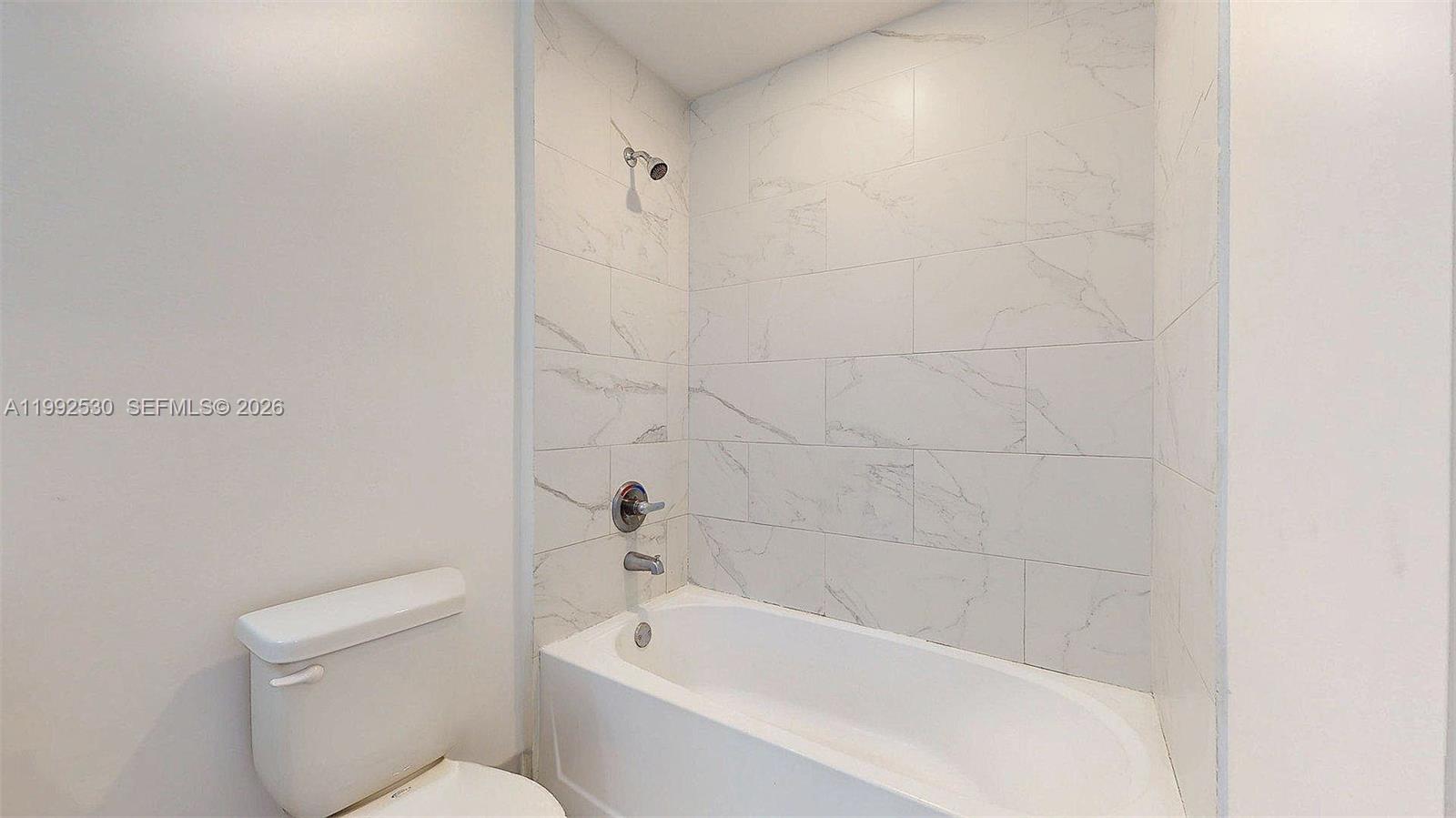 519 Southwest 5th Avenue, Unit 203 Miami, FL 33130 - Photo 15 of 26 a white bath tub sitting next to a white toilet
