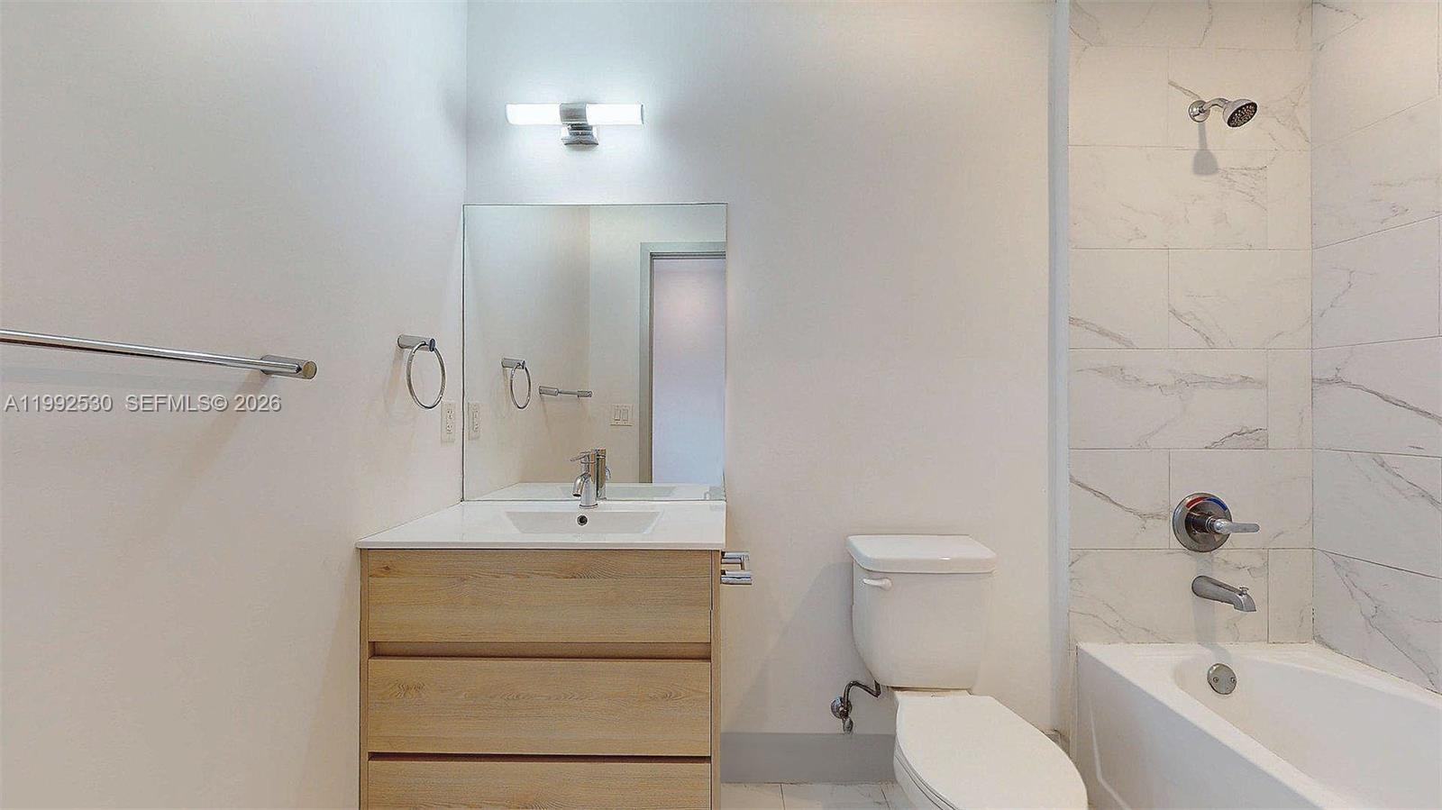 519 Southwest 5th Avenue, Unit 203 Miami, FL 33130 - Photo 17 of 26 a bathroom with a sink a toilet and shower