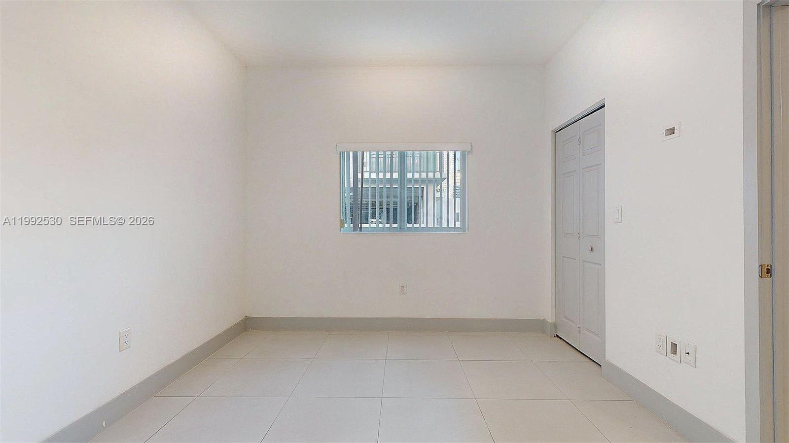 519 Southwest 5th Avenue, Unit 203 Miami, FL 33130 - Photo 18 of 26 an empty room with a window