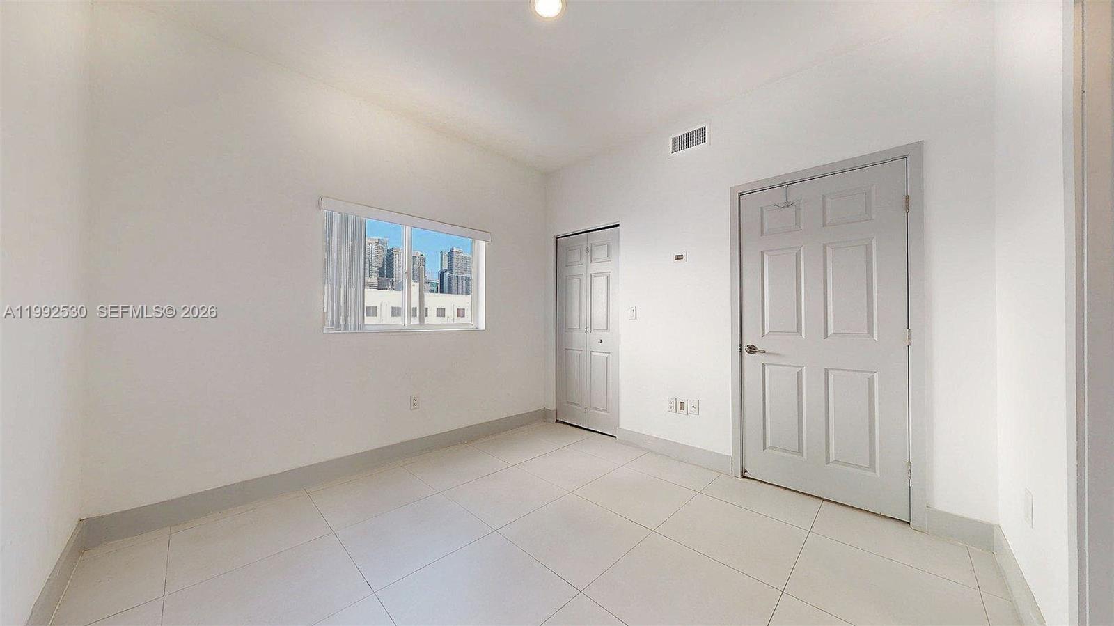 519 Southwest 5th Avenue, Unit 203 Miami, FL 33130 - Photo 20 of 26 a view of an empty room with a window