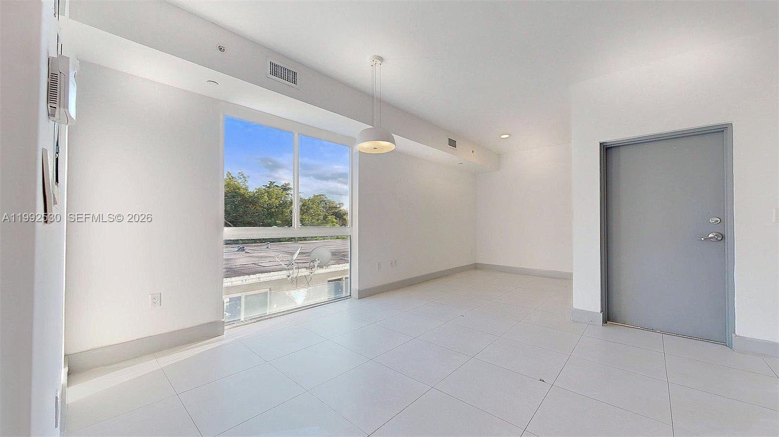 519 Southwest 5th Avenue, Unit 203 Miami, FL 33130 - Photo 8 of 26 a view of an empty room with a window