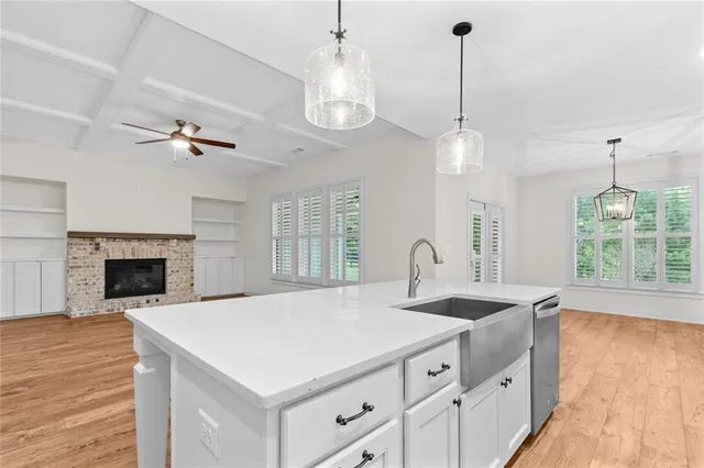 a kitchen with a sink chandelier and a fireplace