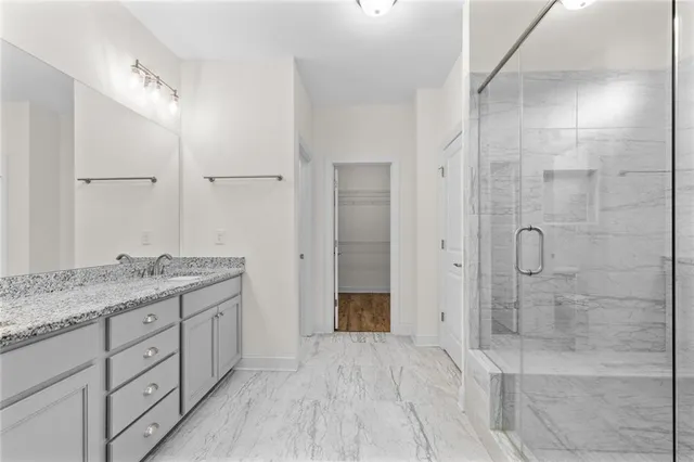 a bathroom with a granite countertop sink mirror and double