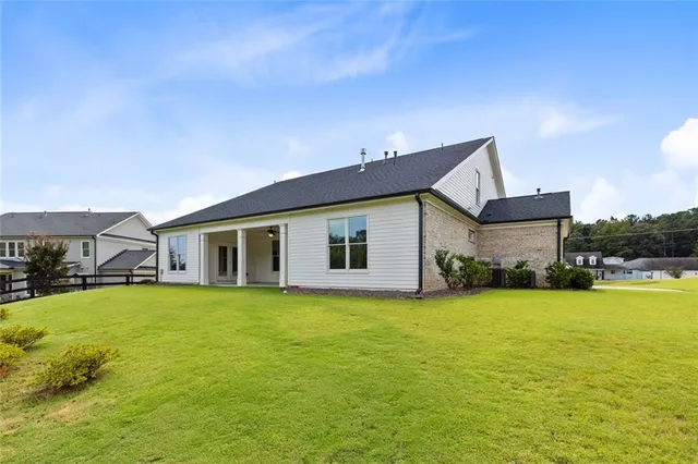 a front view of house with a garden and swimming pool