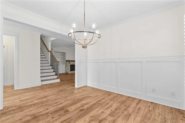 a view of empty room with wooden floor and ceiling fan