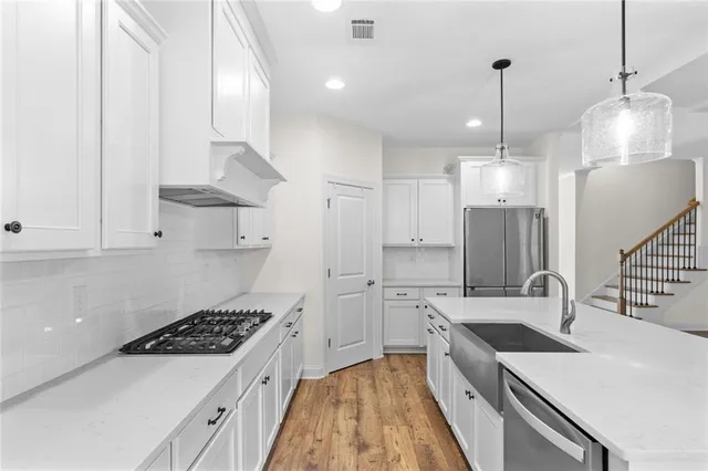 a kitchen with a sink stove and refrigerator