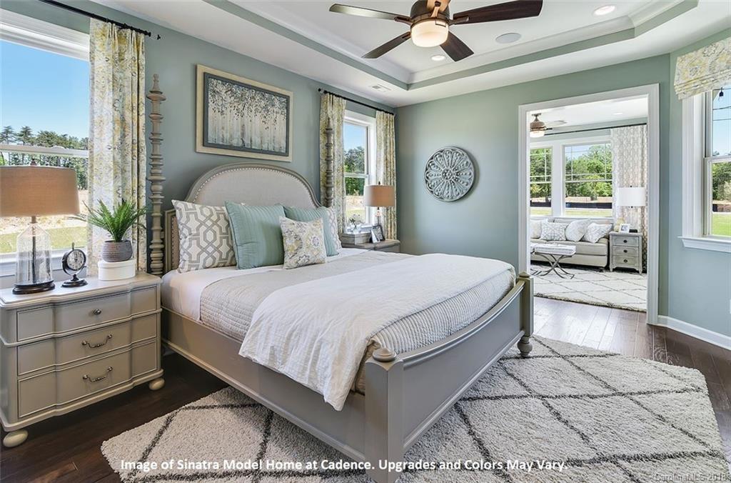 1267 Independence Street, Unit 81 Tega Cay, SC 29708 - Photo 6 of 10 a bedroom with a large bed and a chandelier