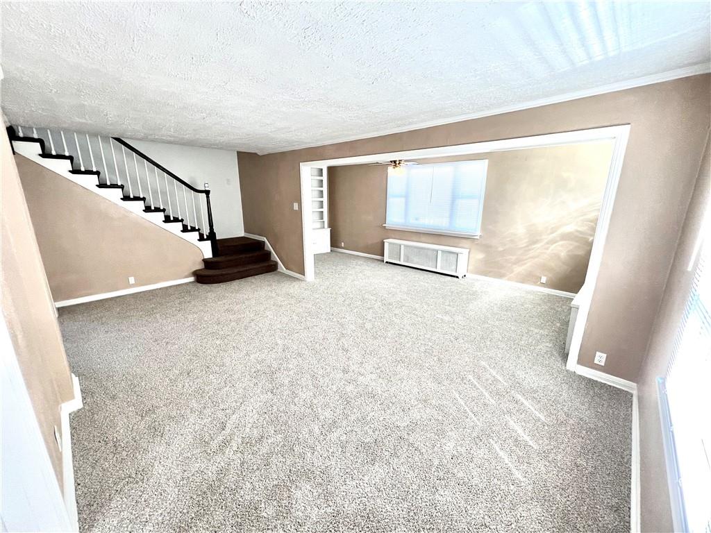 1032 Main Street Republic, PA 15475 - Photo 13 of 39 a view of an empty room with stairs and a window