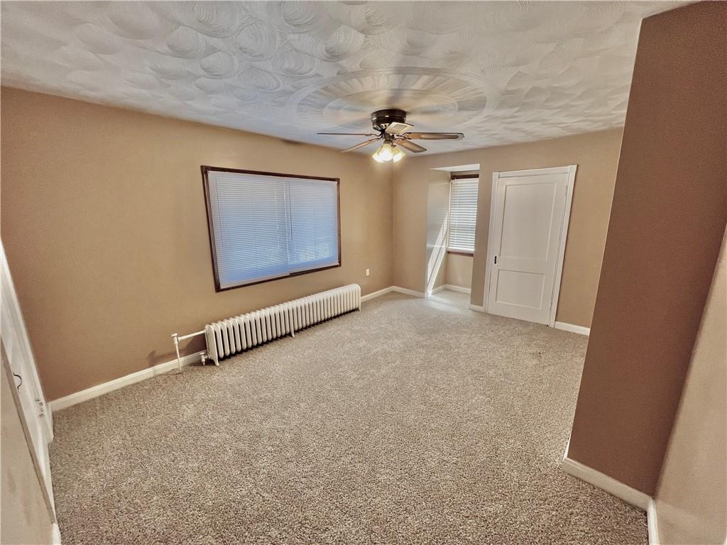 1032 Main Street Republic, PA 15475 - Photo 21 of 39 an empty room with a ceiling fan and a window